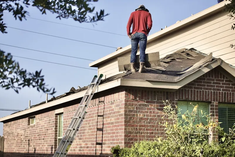 Professional roofer working on a residential roof in Cheeks Crossroads